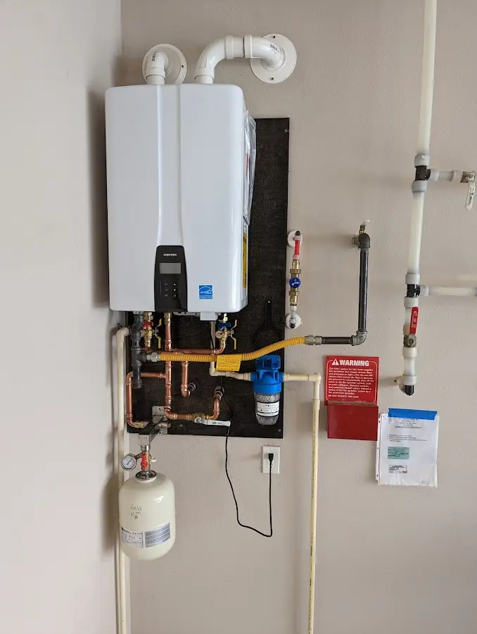 Professional plumber installing copper piping in a Crane home